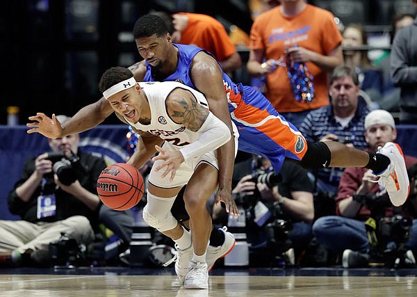 Auburn guard Bryce Brown is fouled by Florida center Kevarrius Hayes in the second half of Saturday's semifinal game at the Southeastern Conference Tournament in Nashville, Tenn. Auburn won 65-62.