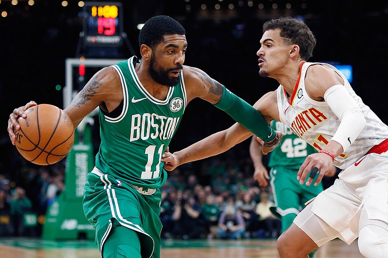 Boston Celtics' Kyrie Irving, left, drives past Atlanta Hawks' Trae Young during the first half of an NBA basketball game in Boston, Saturday, March 16, 2019. (AP Photo/Michael Dwyer)