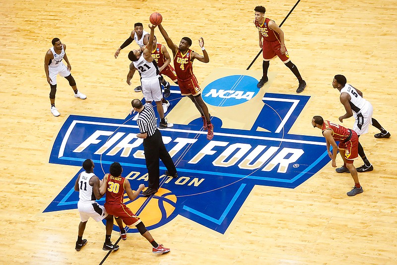 In this March 15, 2017, file photo, Providence's Jalen Lindsey (21) and Southern California's Chimezie Metu (4) vie for the opening tipoff of a First Four game of the NCAA men's college basketball tournament in Dayton, Ohio. After experiencing its best days in the first half of the 20th century, Dayton is reinventing itself with impressive results. Minor-league baseball, a riverside park and a cluster of craft beer pubs are helping revitalize a downtown that had become frayed around the edges. (AP Photo/John Minchillo, File)
