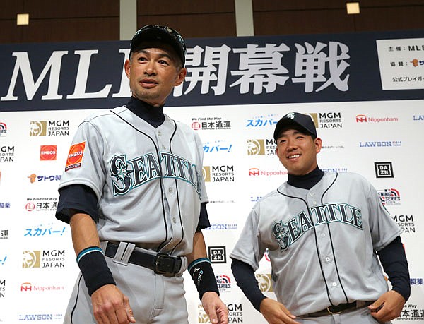 Mariners outfielder Ichiro Suzuki (left) and pitcher Yusei Kikuchi leave after a press conference Saturday in Tokyo.