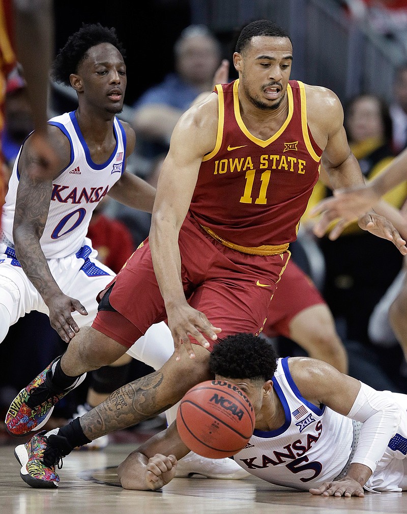 Iowa State guard Talen Horton-Tucker (11) moves around fallen Kansas guard Quentin Grimes (5) during the first half of an NCAA college basketball game in the final of the Big 12 men's tournament in Kansas City, Mo., Saturday, March 16, 2019. (AP Photo/Orlin Wagner)