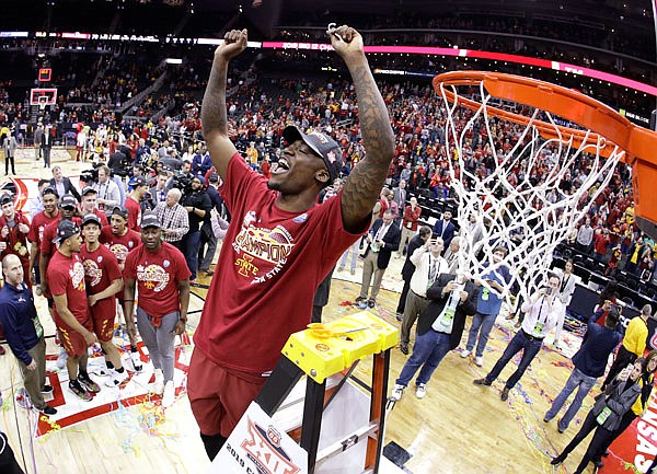 Iowa State's Cameron Lard holds up a piece of the net after the Cyclones defeated Kansas 78-66 in Saturday's championship game to win the Big 12 Tournament at Sprint Center in Kansas City.