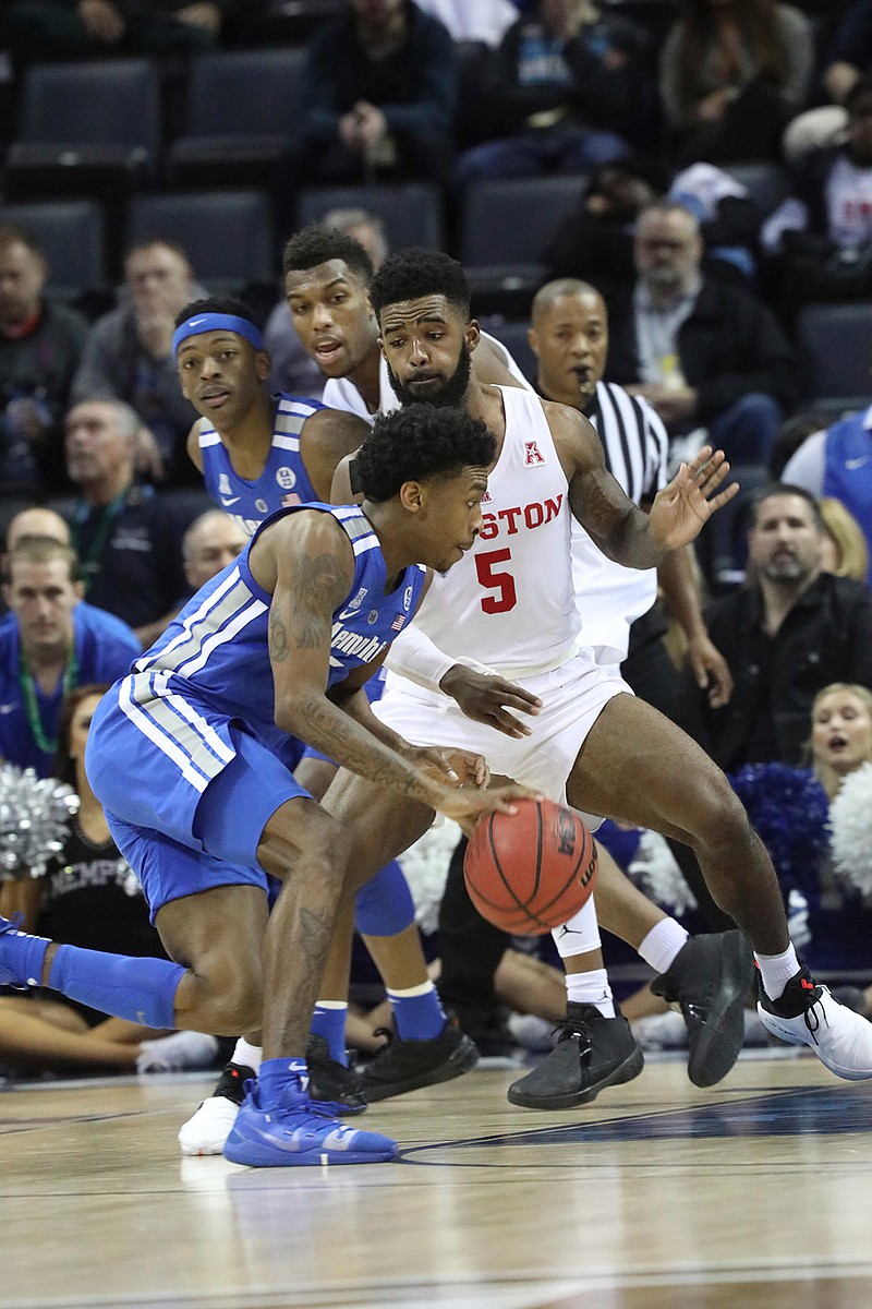 Memphis player Kareem Brewton pushes inside while defended by Houston's Corey Davis Jr. in the second half of an NCAA college basketball game at the American Athletic Conference tournament Saturday, March 16, 2019, in Memphis, Tenn. (AP Photo/Troy Glasgow)