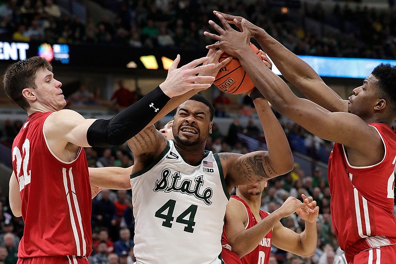 Michigan State's Nick Ward (44) battles for a rebound against Wisconsin's Ethan Happ (22) and Aleem Ford (2) during the second half of an NCAA college basketball game in the semifinals of the Big Ten Conference tournament, Saturday, March 16, 2019, in Chicago. Michigan State won 67-55. (AP Photo/Nam Y. Huh)