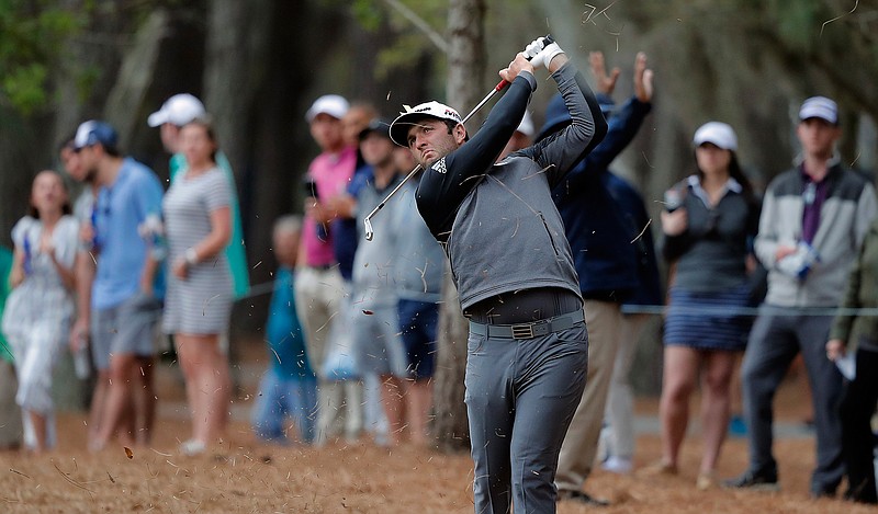 Jon Rahm, of Spain, hits from the pinestraw along the 15th hole during the third round of The Players Championship golf tournament Saturday, March 16, 2019, in Ponte Vedra Beach, Fla. (AP Photo/Gerald Herbert)