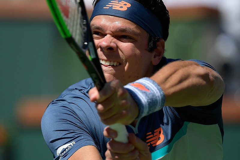 Milos Raonic, of Canada, returns a shot to Dominic Thiem, of Austria, during their semifinal match at the BNP Paribas Open tennis tournament Saturday, March 16, 2019, in Indian Wells, Calif. (AP Photo/Mark J. Terrill)