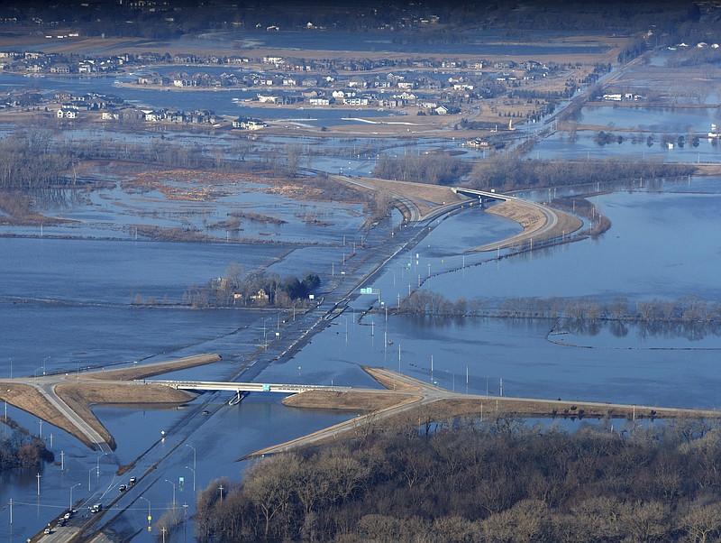 The Elkhorn River consumes a section of western Douglas County Sunday, May 17, 2019, in Omaha, Neb. Hundreds of people were evacuated from their homes in Nebraska and Iowa as levees succumbed to the rush of water. (Jeff Bundy/Omaha World-Herald via AP)