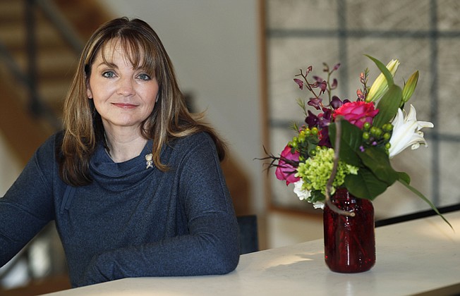  Coni Sanders, whose father was a teacher killed in the 1999 shooting at Columbine High School, poses for a photo Saturday at her home in Denver. A growing movement is urging news organizations to avoid naming the gunmen responsible for mass shootings. The idea is to avoid inspiring more shooters who seek infamy and notoriety. "The media was so fascinated, and so was our country and the world, that they really grasped onto this every detail. Time and time again, we couldn't escape it," Sanders said. 