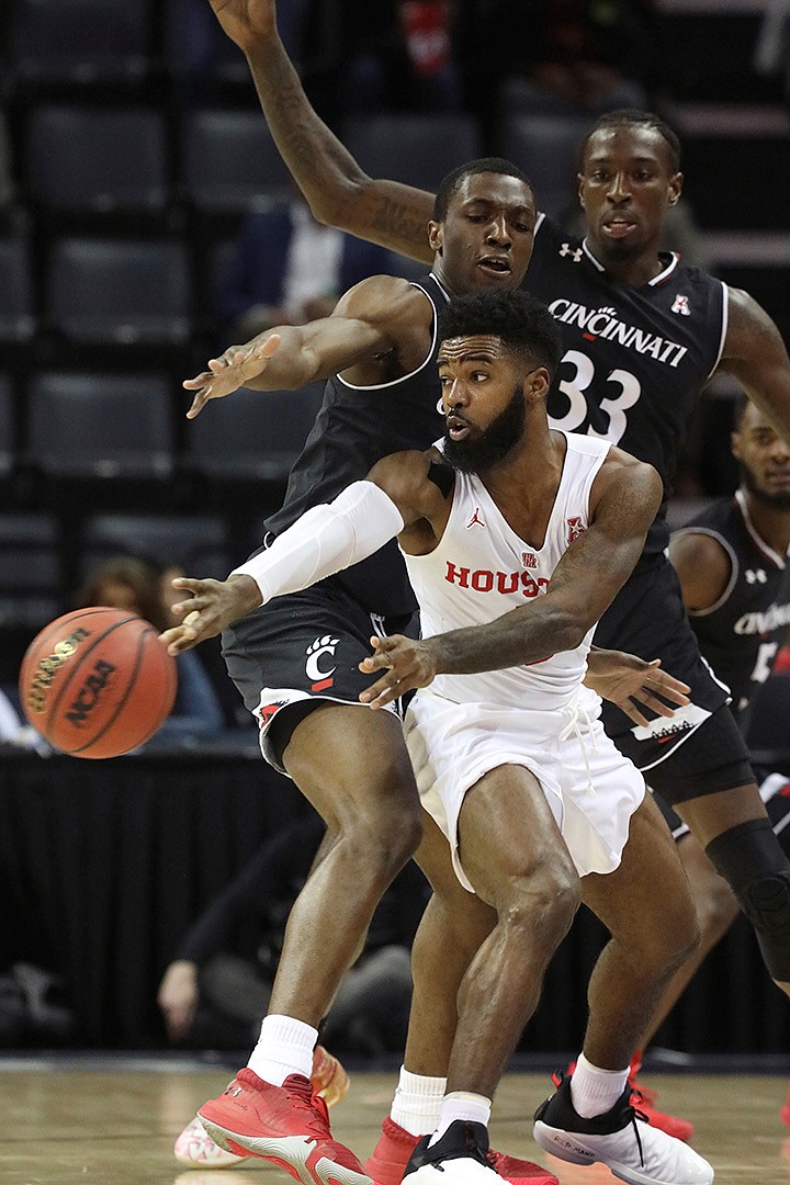  Cincinnati's Keith Williams and Nysier Brooks (33) defend against Houston's Corey Davis Jr. during the first half of the NCAA basketball game for the American Athletic Conference men's tournament championship Sunday in Memphis, Tenn. 
