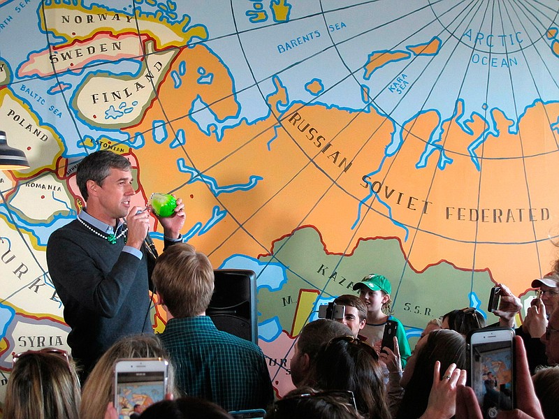 Democratic presidential candidate Beto O'Rourke speaks to supporters Sunday, March 17, 2019, at a coffee shop in Madison, Wis. O'Rourke came in wearing a green cabbage St. Patrick's Day necklace given to him by a supporter during breakfast. 