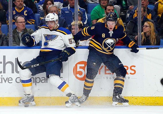 David Perron of the Blues collides along the boards with Casey Nelson of the Sabres during the second period of Sunday afternoon's game in Buffalo.