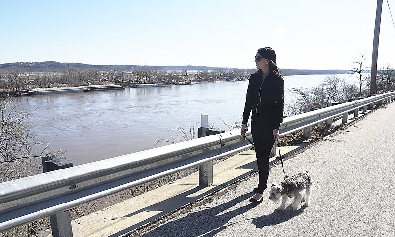 Lydia Roberto looks out over the Missouri River from Water Street in Jefferson City as she walks her dog, Luna, Monday, March 18, 2019.