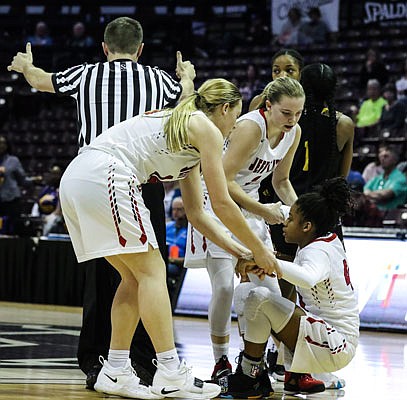 Caitlin Anderson is helped up by Jefferson City teammates Kara Daly and Hannah Nilges during Saturday night's Class 5 state championship game against North Kansas City at JQH Arena in Springfield.