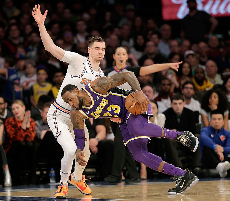  Los Angeles Lakers' LeBron James, right, pushes past New York Knicks' Mario Hezonja on Sunday during the second half of the NBA game in New York. The Knicks defeated the Lakers 124-123. 