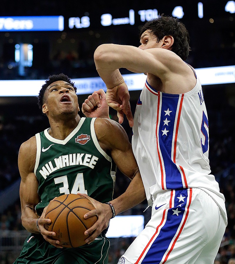 Milwaukee Bucks' Giannis Antetokounmpo looks to shoot against Philadelphia 76ers' Boban Marjanovic during the second half of an NBA basketball game Sunday in Milwaukee. 