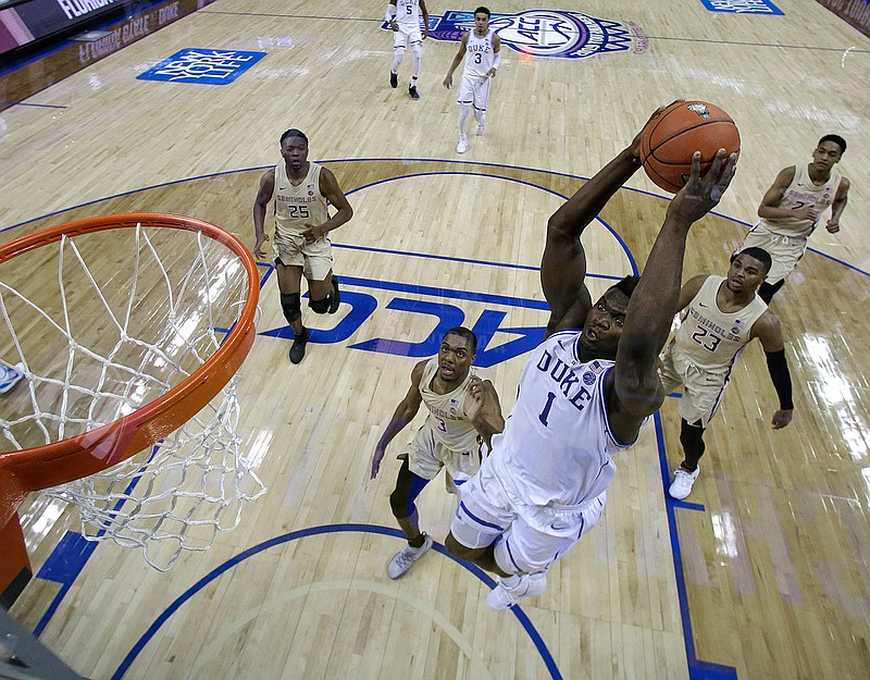 Duke's Zion Williamson (1) goes up to dunk against Florida State during the first half of the NCAA basketball championship game of the Atlantic Coast Conference tournament on Sunday in Charlotte, N.C. The NCAA tournament starts Tuesday, and Duke landed the No. 1 seed overall. 