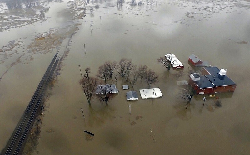 This Tuesday, March 19, 2019 aerial photo shows flooding along the Missouri River in Pacific Junction, Iowa. The U.S. Army Corps of Engineers says rivers breached at least a dozen levees in Nebraska, Iowa and Missouri. Hundreds of homes are damaged, and tens of thousands of acres are inundated with water.