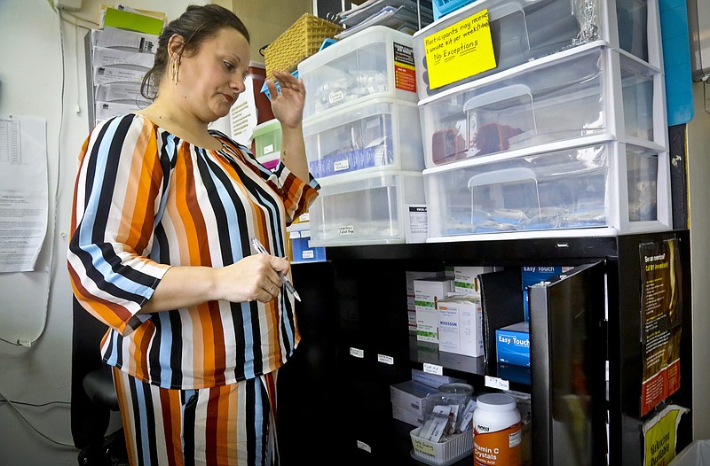 In this Friday, March 15, 2019 photo, Laura Levine prepares to stock sterile supplies at the syringe exchange at Vocal NY, an organization that works with addicts, where she is the health educator and coordinator for the opioid reversal drug Narcan, in the Brooklyn borough of New York. New York state is considering providing medication-assisted treatment to all prison and jail inmates struggling with opioid addiction. (AP Photo/Bebeto Matthews)