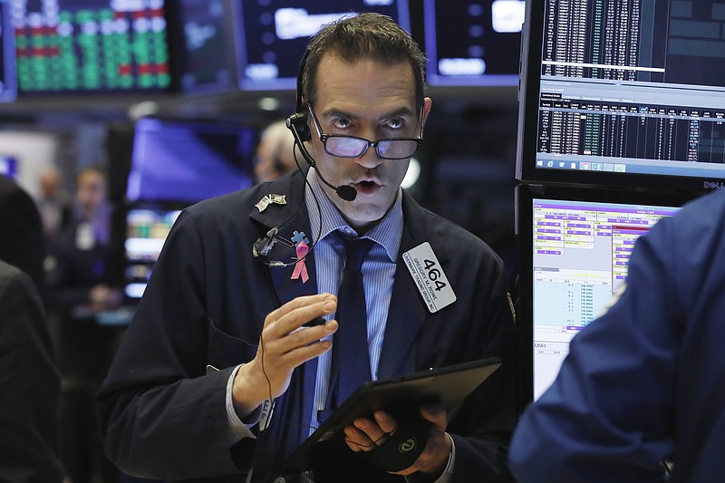 FILE- In this March 13, 2019, file photo Gregory Rowe works on the floor of the New York Stock Exchange. The U.S. stock market opens at 9:30 a.m. EDT on Tuesday, March 19. (AP Photo/Richard Drew, File)