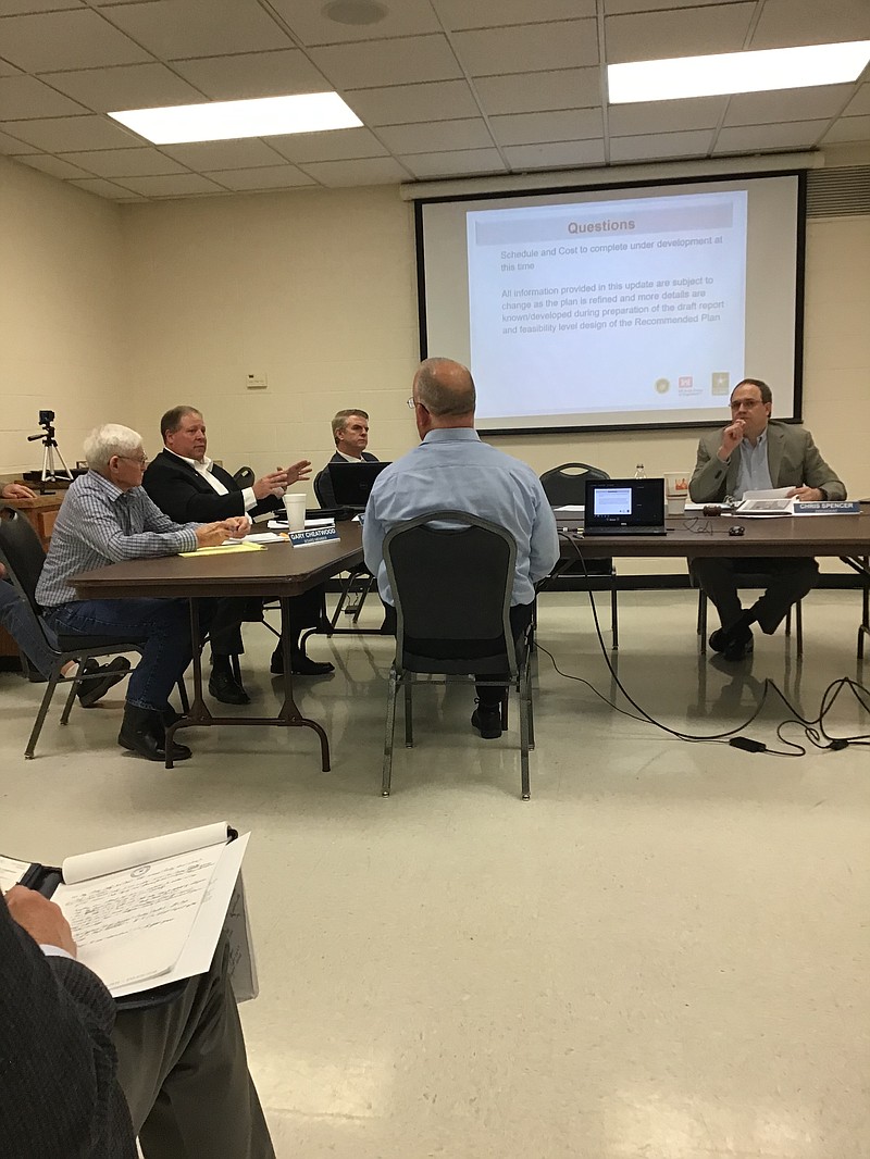 Rob Newman with the U.S. Army Corps of Engineers' Fort Worth District, center, speaks to the Sulphur River Basin Authority's Board of Directors Tuesday about the feasibility study to determine a Tentatively Selected Plan to reallocate Wright Patman Lake from flood storage to water supply and raise it to 235 from 228.64. If SRBA is given additional funding from JCPD, the study could be complete in four to five months, Newman said. Shown are, from left, SRBA Board Members Gary Cheatwood and Kelly Mitchell, SRBA Attorney Brian Sledge, Newman and Chairman Chris Spencer.