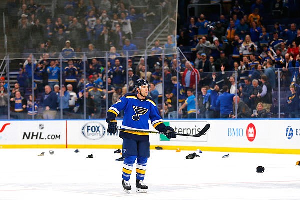 Fans throw their hats on the ice after Jaden Schwartz of the Blues completes a hat trick during the third period of Tuesday's game against the Oilers in St. Louis.