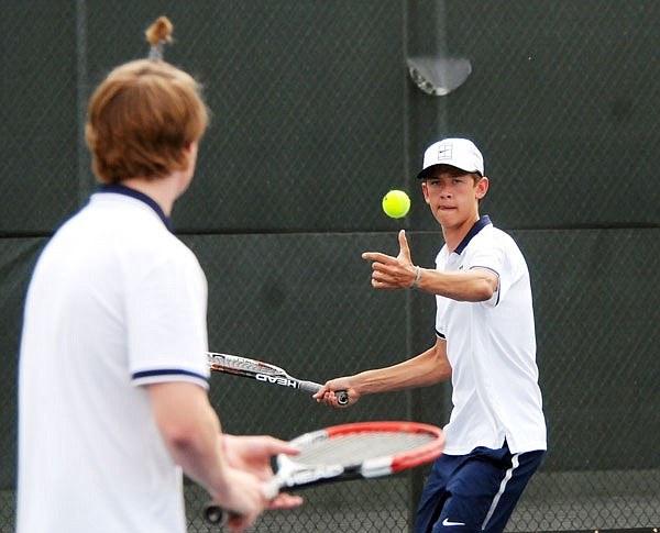 Jacob Cowley of Helias returns a shot in doubles play during a match last season against School of the Osage at the Crusader Athletic Complex.