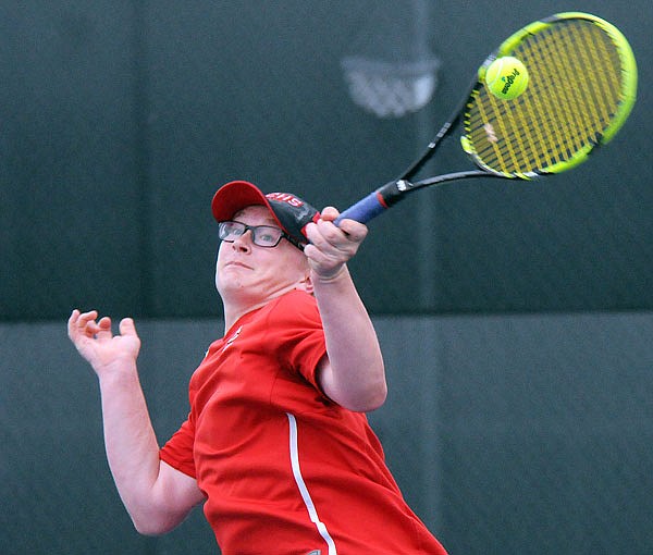 Josh Wilde of the Jays returns a shot during last season's dual match against Helias at the Crusader Athletic Complex.