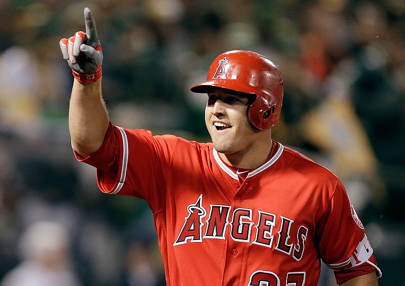 In this April 3, 2017, file photo, Los Angeles Angels' Mike Trout celebrates after hitting a two-run home run off Oakland Athletics' Kendall Graveman in the third inning of a baseball game in Oakland, Calif. A person familiar with the negotiations tells The Associated Press Tuesday, March 19, 2019, that Trout and the Angels are close to finalizing a record $432 million, 12-year contract that would shatter the record for the largest deal in North American sports history. (AP Photo/Ben Margot, File)