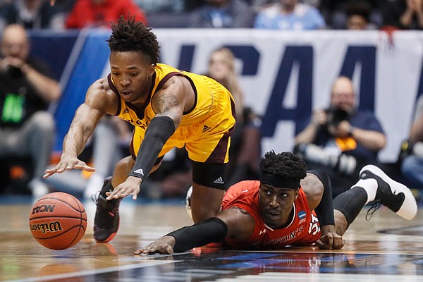 Arizona State's Kimani Lawrence and St. John's Sedee Keita, dive for a loose ball during the first half of Wednesday night's First Four game in Dayton, Ohio.