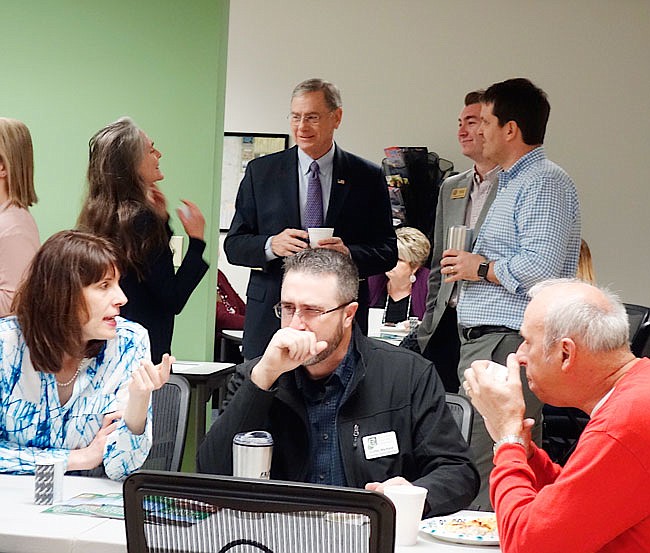 U.S. Rep. Blaine Luetkemeyer (standing, center) speaks with constituents Wednesday morning at the Callaway Chamber of Commerce's business breakfast. He offered his opinions about the proposed border wall with Mexico, necessary cuts to senior programs Medicare and Social Security, and other topics.