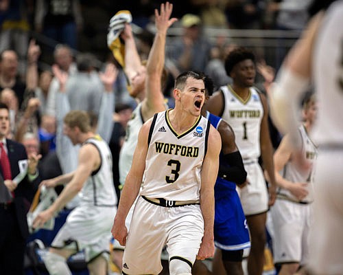 Wofford guard Fletcher Magee celebrates with teammates after hitting a 3-point shot during the final moments of the second half in Thursday night's NCAA Tournament game against Seton Hall  in Jacksonville, Fla.