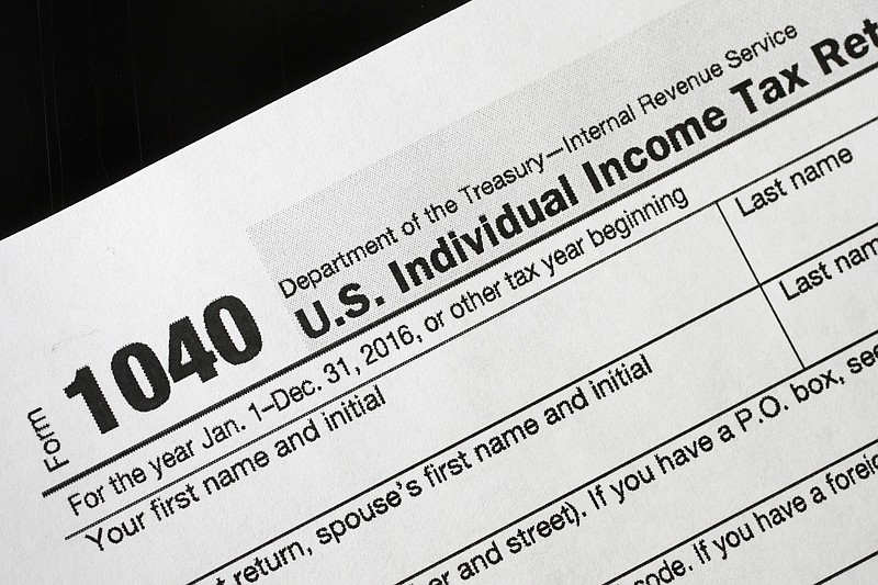 AP FILE - A 1040 tax form appears on display.