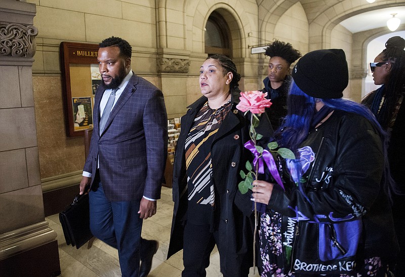Rose family attorney, S. Lee Merritt, left, and Michelle Kenney, center, mother of Antwon Rose II, walk towards members of the media following the closing arguments in the homicide trial of former East Pittsburgh Police officer Michael Rosfeld, Friday, March 22, 2019. at the Allegheny County Courthouse in Pittsburgh. A jury has started deliberating in the homicide trial of Rosfeld, a white former police officer charged with killing Rose, an unarmed black teenager outside Pittsburgh last summer.(Nate Smallwood/Pittsburgh Tribune-Review via AP, Pool)