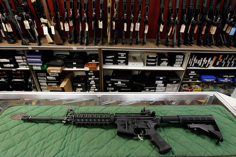 In this Thursday, July 26, 2012 file photo, an AR-15 style rifle is displayed at the Firing-Line indoor range and gun shop, in Aurora, Colo. A new poll shows a majority of Americans favor stricter gun laws, and most believe schools and places of worship have become less safe over the last two decades, according to a poll conducted by The Associated Press-NORC Center for Public Affairs Research both before and after last week's mass shooting at two mosques in New Zealand. (AP Photo/Alex Brandon, File)