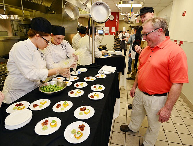 Hungry visitors watch as culinary students show off their handy work during a reception last week at the Nichols Career Center culinary kitchen.