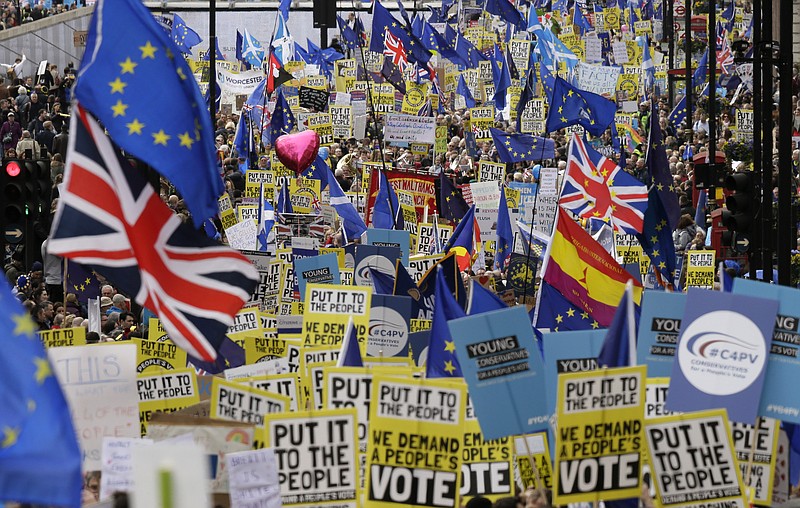 Demonstrators carry posters and flags during a Peoples Vote anti-Brexit march in London, Saturday, March 23, 2019. The march, organized by the People's Vote campaign is calling for a final vote on any proposed Brexit deal. This week the EU has granted Britain's Prime Minister Theresa May a delay to the Brexit process. (AP Photo/Tim Ireland)