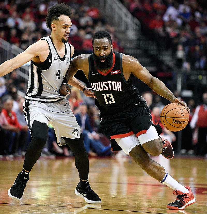 Houston Rockets guard James Harden (13) dribbles past San Antonio Spurs guard Derrick White during the second half of an NBA basketball game Friday, March 22, 2019, in Houston. Houston won 111-105. (AP Photo/Eric Christian Smith)