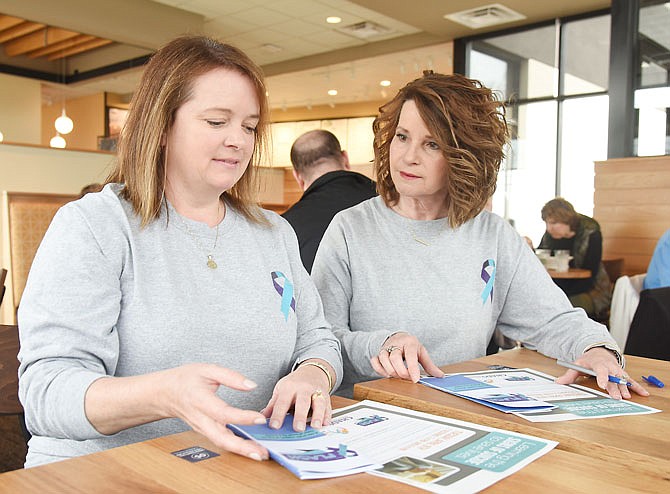 Laura Landwehr, left, and Barb Gordon, co-founders of In A Flash — a support group for people who've lost a loved one to suicide — plan an upcoming event. Landwehr's sister and Gordon's husband died of suicide and they do not want people to be afraid to talk about the issue or seek help if they are thinking of committing suicide.