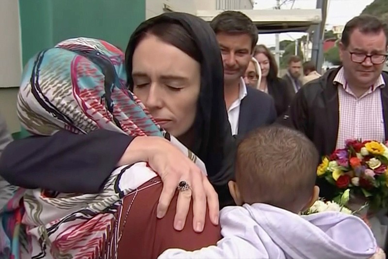 In this image made from video, New Zealand's Prime Minister Jacinda Ardern, center, hugs and consoles a woman March 17, 2019, as she visits Kilbirnie Mosque in Wellington, New Zealand. Ardern was hailed around the world for her decisive response to the two mosque shootings by a white nationalist who killed 50 worshippers.