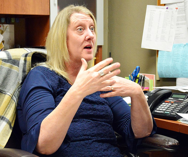 Nichols Career Center Director Sharon Longan talks to a reporter in her office.