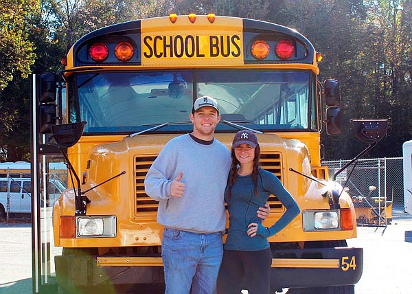 In this Oct. 30, 2018, file photo, Jack Labosky (left) and Madi Hiatt pose after purchasing a school bus in Lynchburg, Va. Labosky is a minor league pitcher in the Rays organization, and he and Hiatt, his girlfriend, plan to live out of the bus during his first full professional season.
