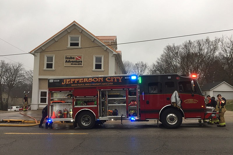 Jefferson City firefighters battled a blaze Monday, March 25, 2019, that caused heavy damage to the building housing Scuba Adventure at 901 Jefferson St.