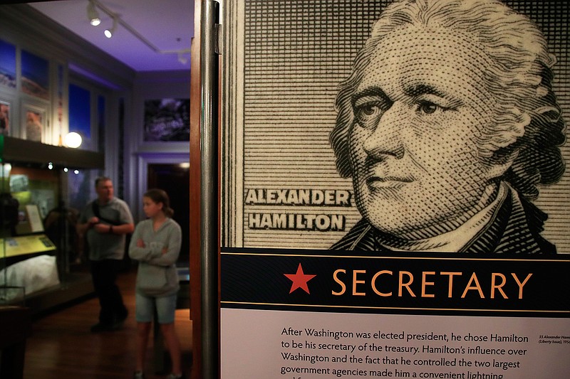 This June 11, 2018 file photo shows an Alexander Hamilton exhibit called "Alexander Hamilton: Soldier, Secretary, Icon," at Smithsonian National Postal Museum in Washington. Hamilton, determined to transform America into an industrial power, argued in 1791 that the United States needed "to procure all such machines as are known in any part of Europe." Trouble was, Britain, the world's technological leader, closely guarded its advantages. (AP Photo/Manuel Balce Ceneta, File)