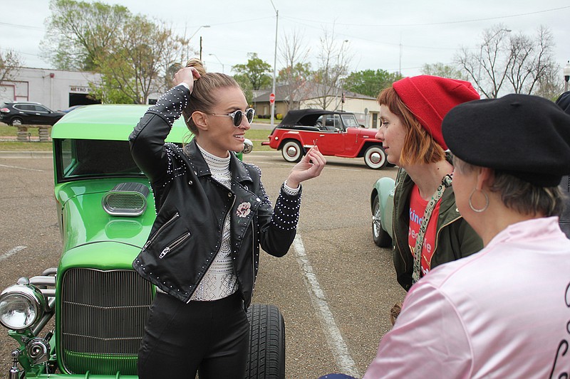 Performer Stephanie Rice, left, talks with Vicki Carr, far right, Saturday at the downtown car show during the "Ragtime to Rockabilly Weekend." Rice was one of the judges of the vintage car show that took place in the parking lot of the Arkansas Municipal Auditorium. 