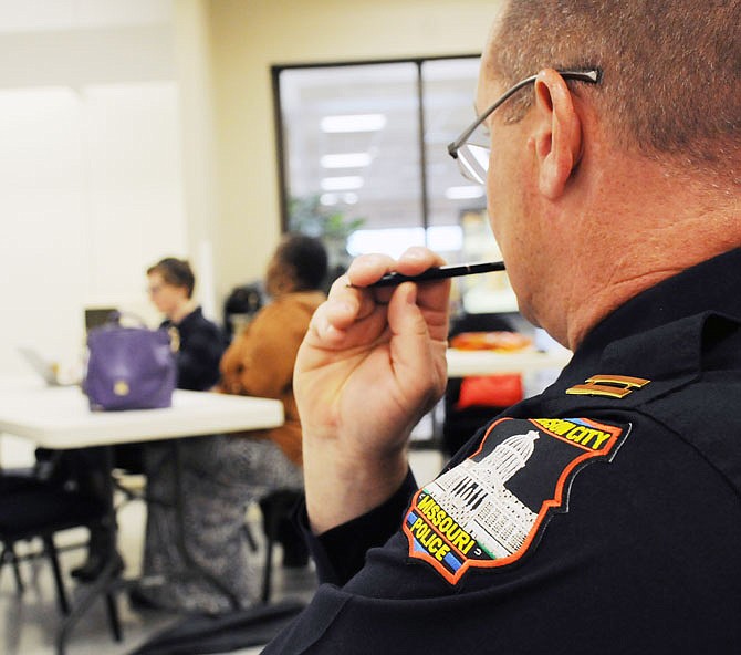 Capt. Eric Wilde, with the Jefferson City Police Department, listens to Leana Mahaney discuss a recent interaction with the police March 30 during a police and community relations listening session at the Capital Mall's Community Room.