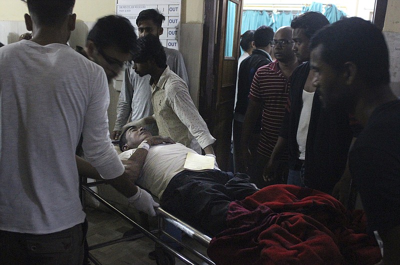 An Injured of rain storm from Bara district is being brought to a government hospital, in Birgunj, 136 kilometers (85 miles) from Kathmandu, Nepal, March 31, 2019. Officials say many people were killed and hundreds were injured by a rainstorm that swept southern Nepal on Sunday. (AP Photo/Jiyalal Sah)