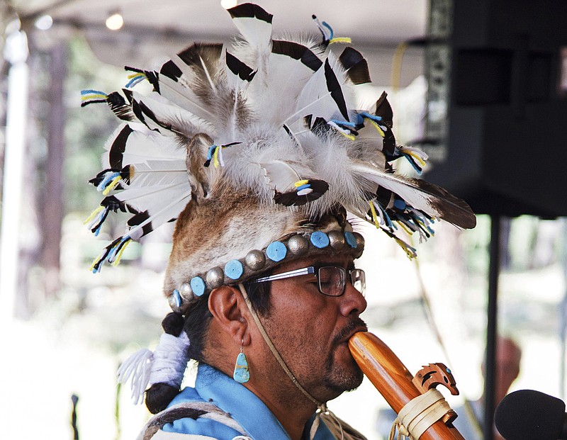 This 2017 photo provided by the Museum of Northern Arizona shows an unidentified man wearing a headpiece fashioned out of an animal hide at the Navajo Festival of Arts and Culture in Flagstaff, Ariz. The hide did not come from a state wildlife repository, but the photo shows how Native Americans use animal parts for religious and cultural purposes. Arizona wildlife officials are on the lookout for bear, bison, badger and other carcasses for Native Americans' religious and cultural use under a unique new program that allows tribes to make requests for various animal parts. (Ryan Williams/Museum of Northern Arizona via AP)