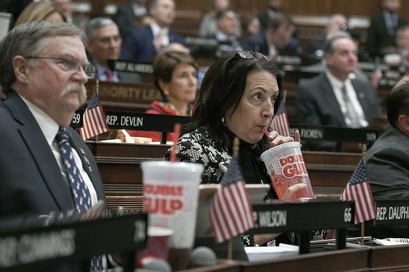 FILE - In this Feb. 20, 2019 file photo, state Rep. Anne Dauphinais R-Killingly, takes a sip from a big gulp soda as Connecticut Democrat Gov. Ned Lamont delivers his budget address at the State Capitol in Hartford, Conn. Lamont proposed a tax on sugary drinks in his first budget. Connecticut is among several states likely to see debate this year over taxes that advocates endorse as way to reduce consumption of liquid calories. On March 25 the American Academy of Pediatrics and the American Heart Association called for education campaigns and raising prices through taxes to reduce consumption of sugary drinks by young people. (AP Photo/Jessica Hill, File)