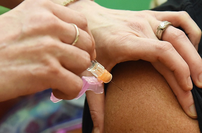 An influenza shot is administered.