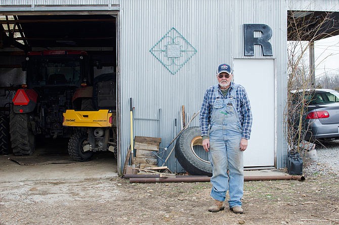 Marian Reed, a farmer living north of California, stands in front of a shed on his property. Deer will often damage crops on his property, causing $1,000 in damages to soybeans last year.